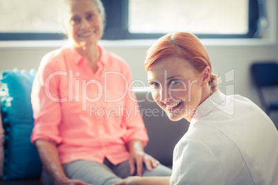 Nurse giving leg massage to woman