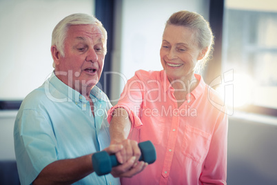Senior couple exercising at home