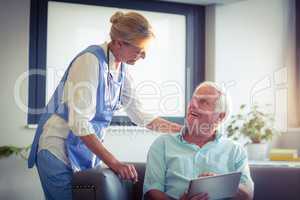 Senior man and female doctor interacting with each other