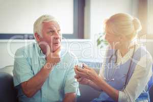Senior man talking with female doctor