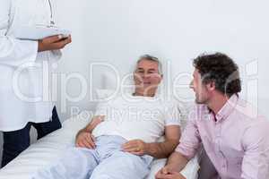 Man sitting next to patient