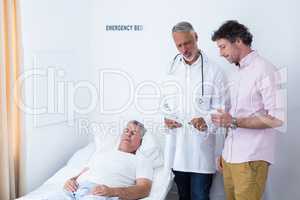 Male doctor discussing medical report with man
