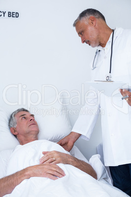 Male doctor examining senior man