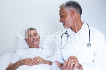 Male doctor and senior man interacting with each other