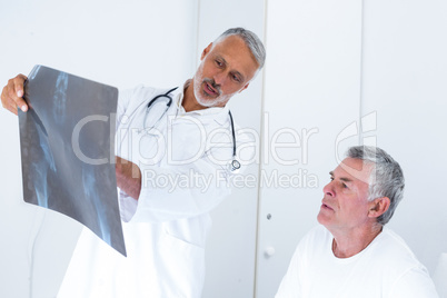 Male doctor discussing x-ray with senior man