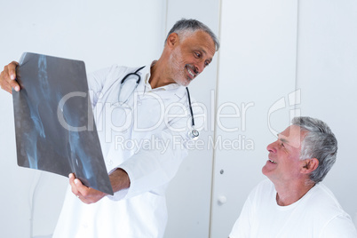 Male doctor discussing x-ray with senior man