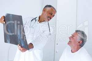 Male doctor discussing x-ray with senior man