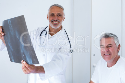 Male doctor discussing x-ray with senior man