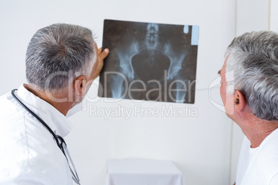 Male doctor discussing x-ray with senior man