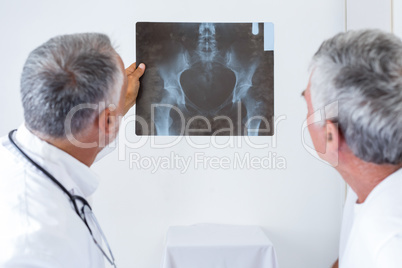 Male doctor discussing x-ray with senior man