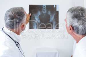 Male doctor discussing x-ray with senior man