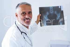 Male doctor holding x-ray