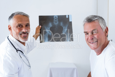 Male doctor discussing x-ray with senior man