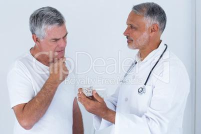 Male doctor advising senior man on medical prescriptions