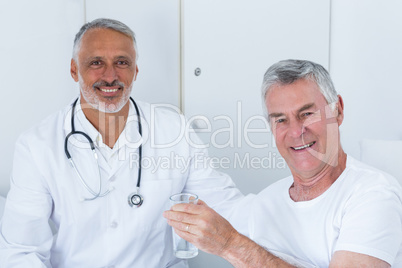 Portrait of happy male doctor and senior man