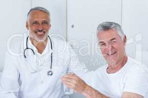 Portrait of happy male doctor and senior man
