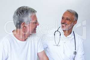 Male doctor and senior man interacting with each other