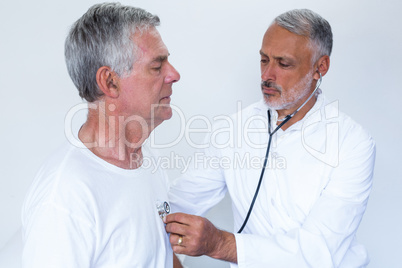 Doctor examining a senior man