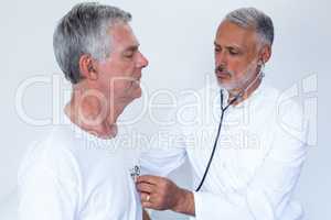 Doctor examining a senior man