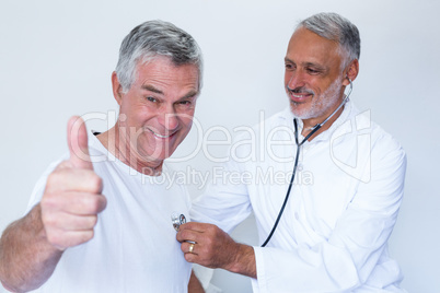 Doctor examining a senior man