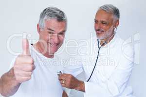 Doctor examining a senior man