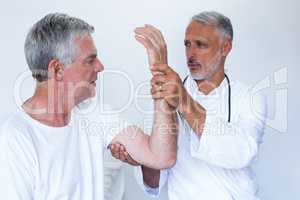 Doctor examining a senior man