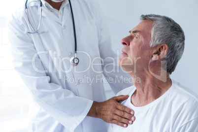 Doctor examining a senior man