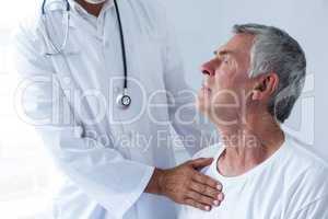 Doctor examining a senior man