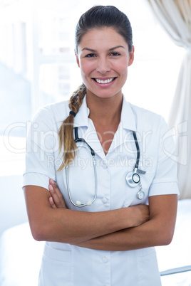 Portrait of female doctor standing with arms crossed