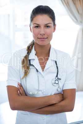 Portrait of female doctor standing with arms crossed