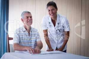 Female doctor helping patient in reading the braille book