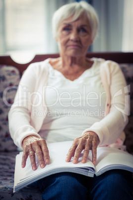 Blind woman reading a braille book