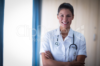 Portrait of female doctor standing with arms crossed