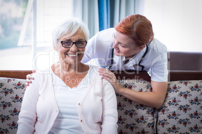 Doctor consoling senior woman