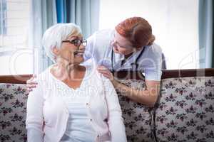 Smiling doctor talking to a happy senior woman