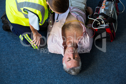 Paramedic using an external defibrillator during cardiopulmonary resuscitation