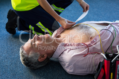 Paramedic using an external defibrillator during cardiopulmonary resuscitation