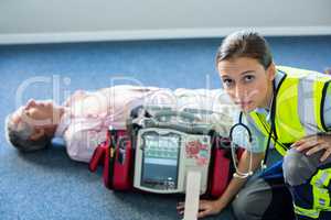 Paramedic using an external defibrillator during cardiopulmonary resuscitation