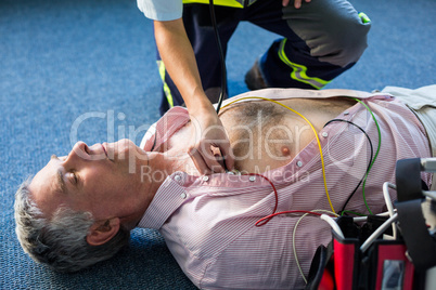 Paramedic examining a patient during cardiopulmonary resuscitation