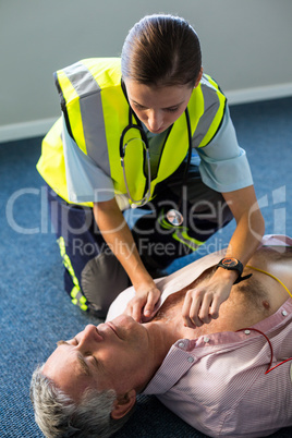 Paramedic using an external defibrillator during cardiopulmonary resuscitation