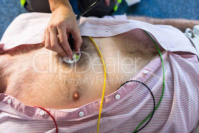Paramedic examining a patient during cardiopulmonary resuscitation