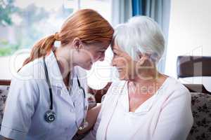 Smiling doctor and patient looking face to face