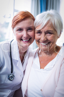 Portrait of happy patient and doctor