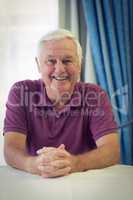 Portrait of senior man sitting in medical clinic