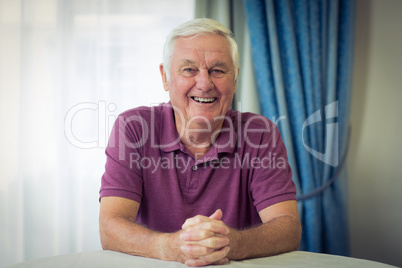 Portrait of senior man sitting in medical clinic