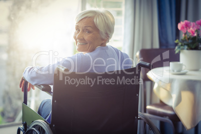 Portrait of smiling senior woman senior woman sitting on wheelchair