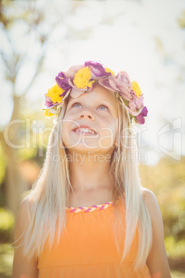 Young girl looking up and smiling in park