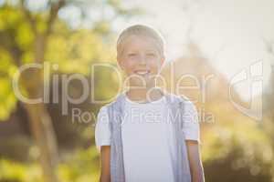 Young boy smiling in park