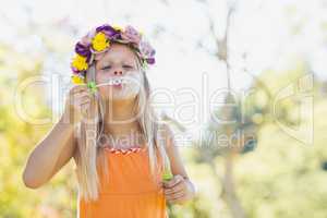 Young girl blowing bubbles through bubble wand