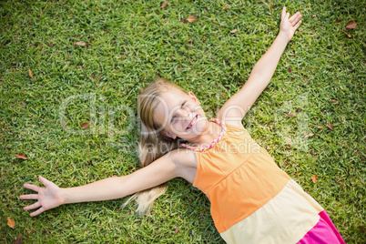 Young girl lying on grass